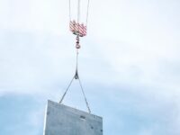 overhead crane lifting concrete block